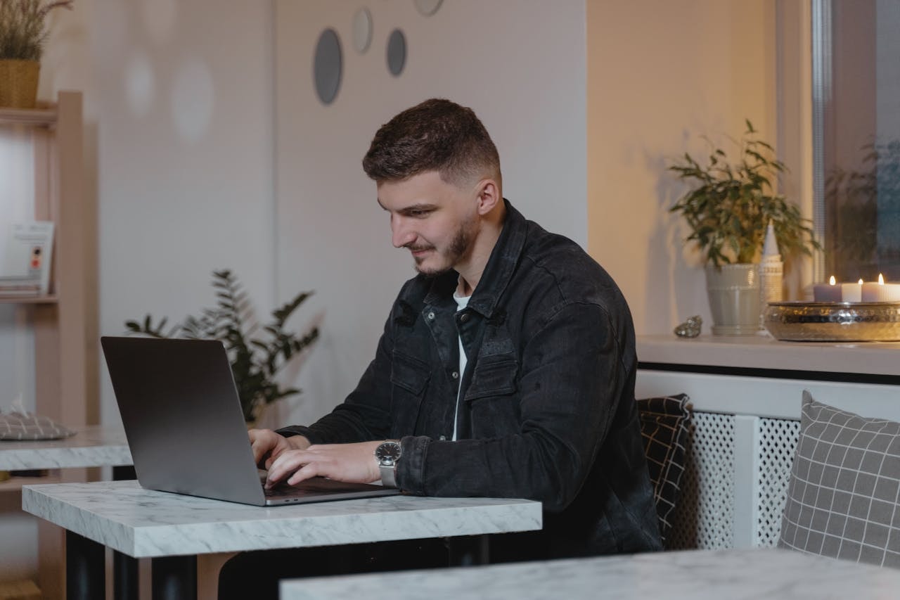 A man typing on a laptop