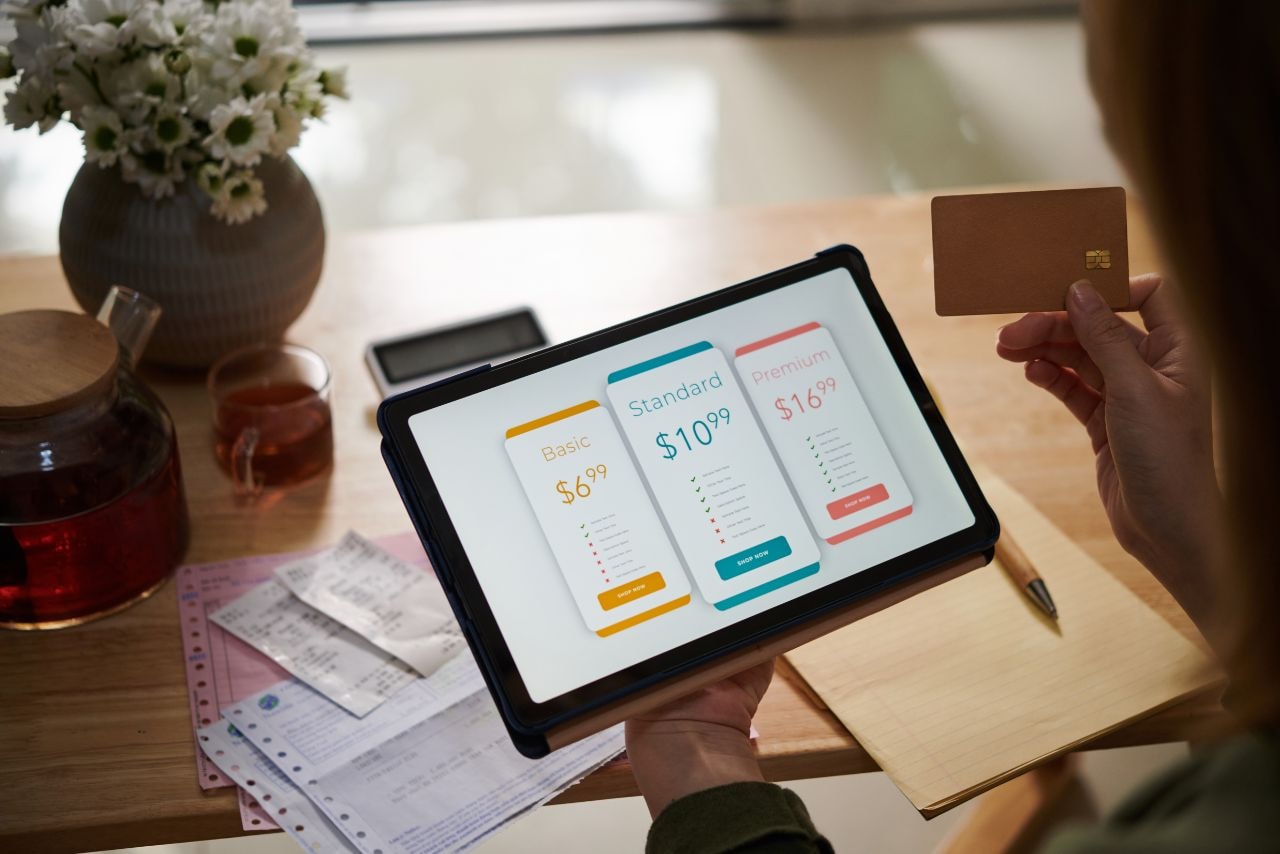 A person paying for a subscription plan online via tablet.