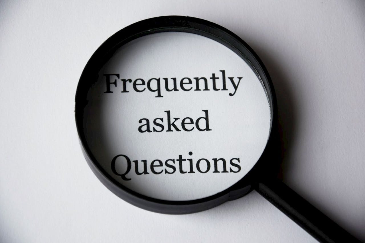 A photo of black magnifying glass over text Frequently asked questions