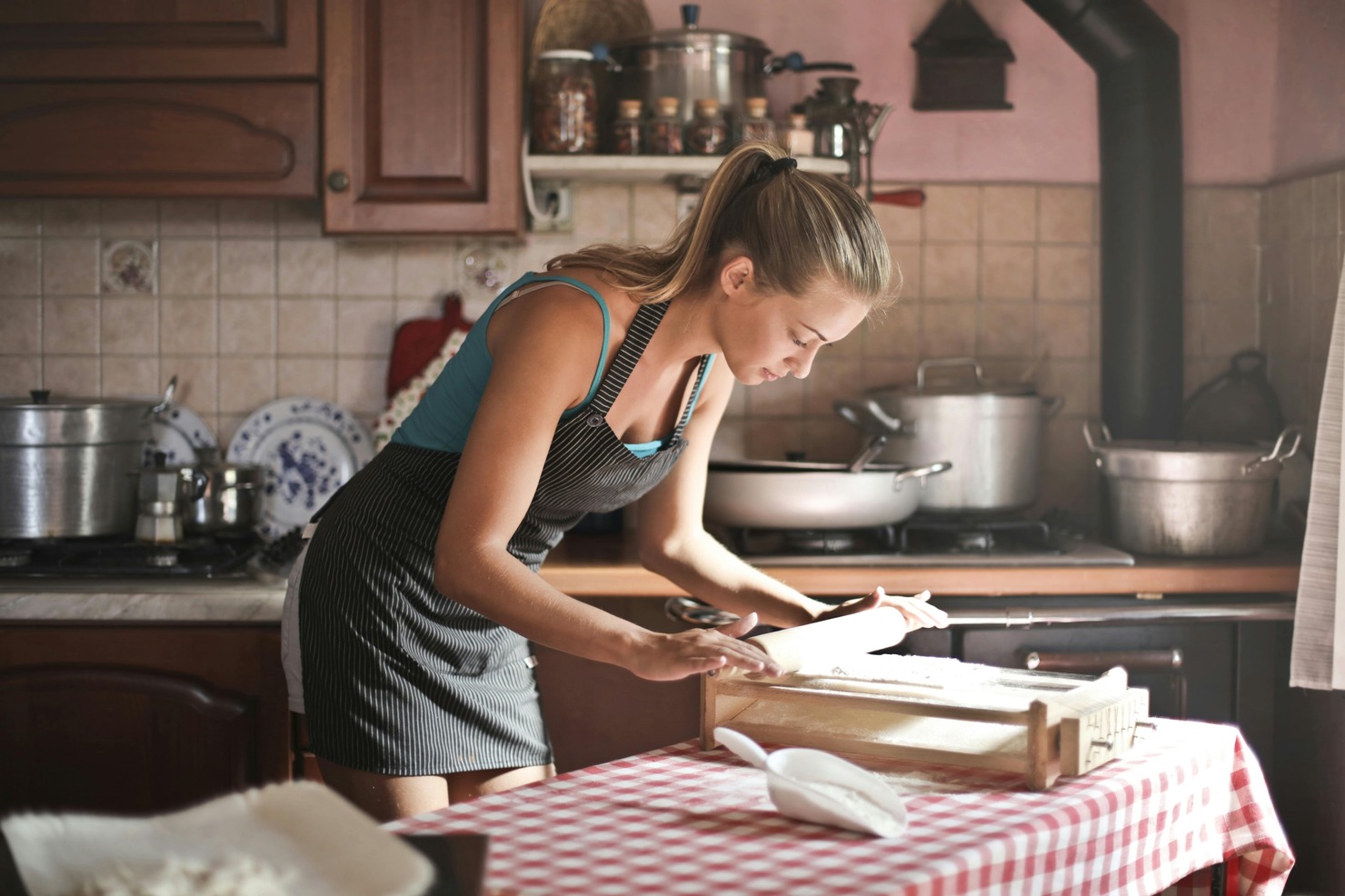 A woman is preparing food for meal prep business.