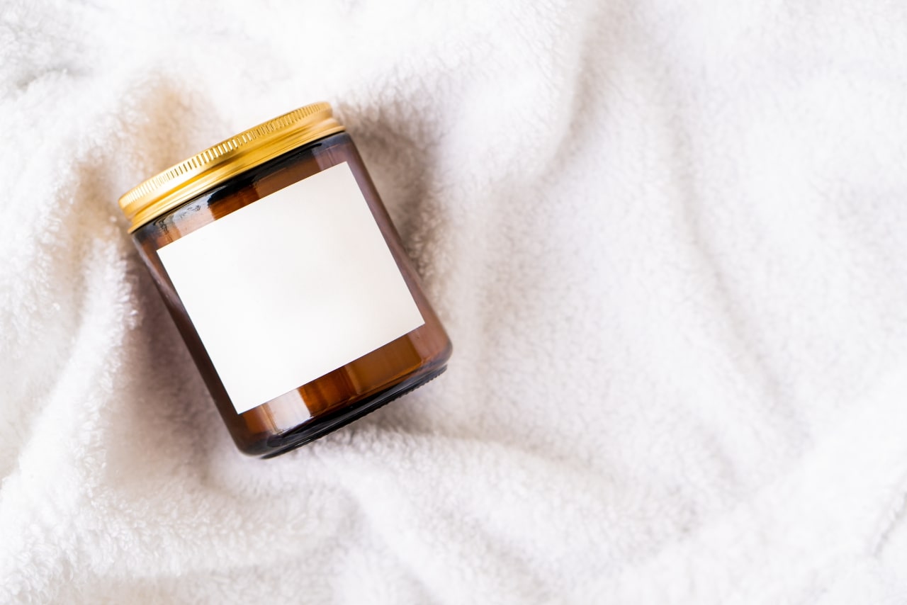 Amber Glass Jar with Metal Lid and White Blank Label.