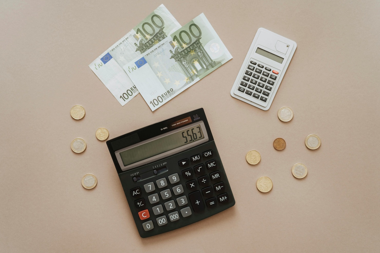 Cash, coins, and calculators arranged.