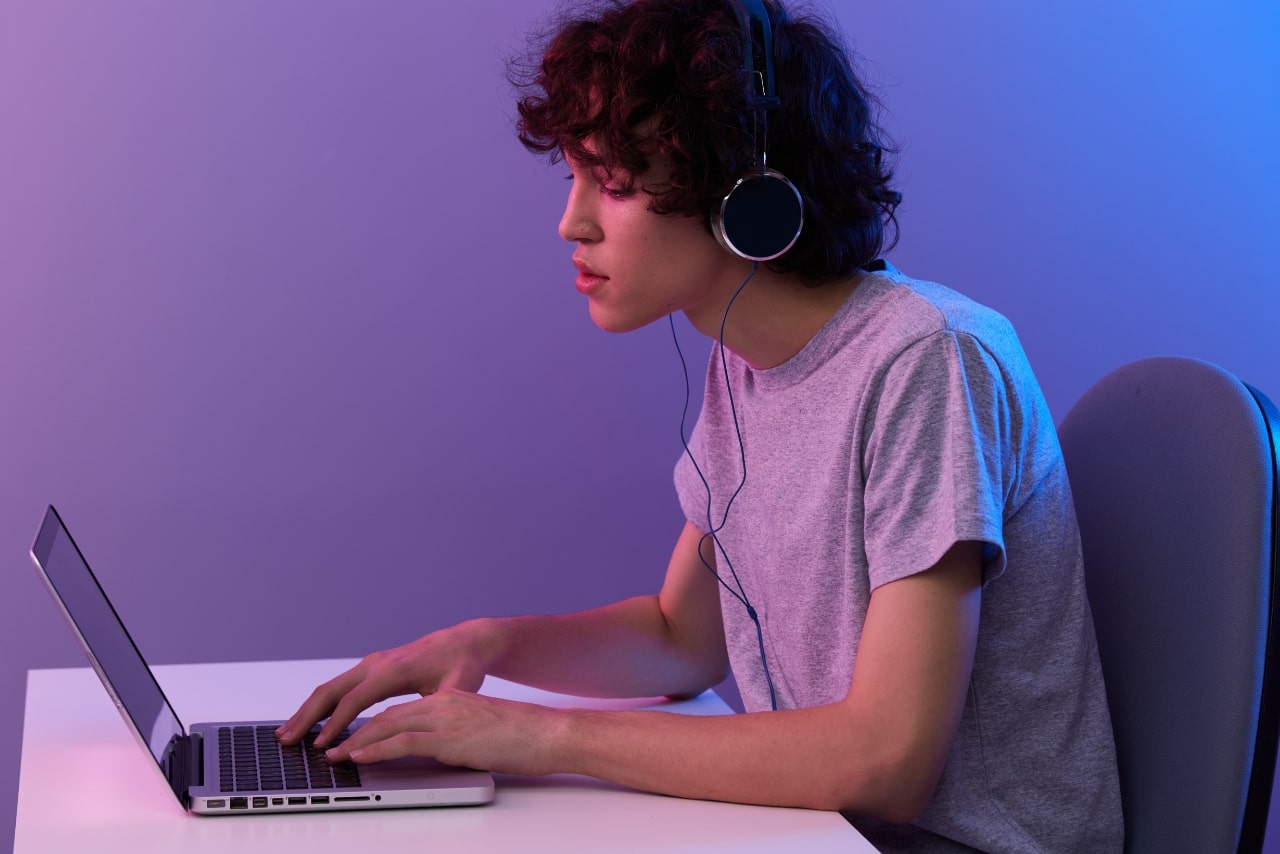 Curly boy watching online tv on computer.