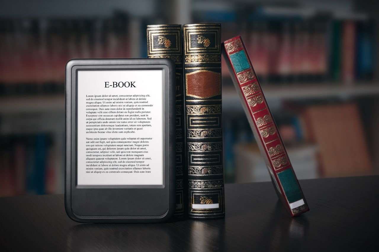 E-book reader device on desk in library.