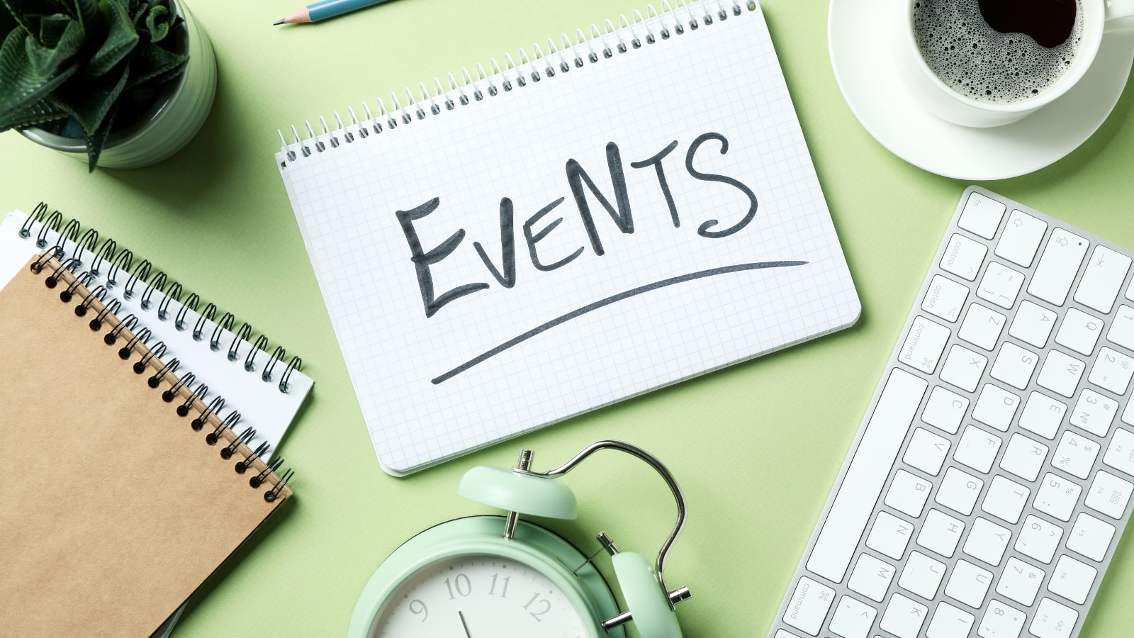 Events Concept with Alarm Clock on Green Background.
