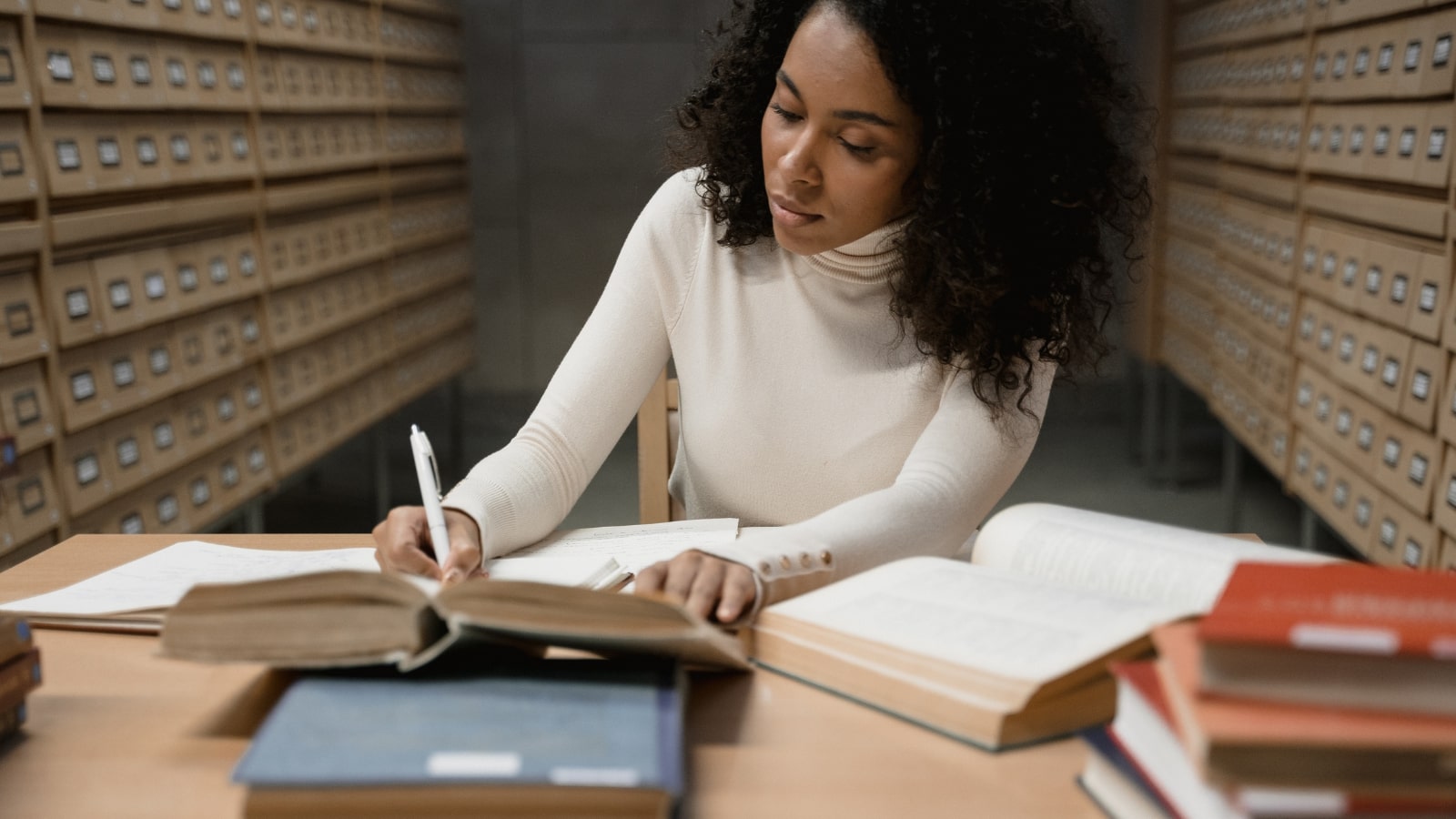 Female doing research in library.