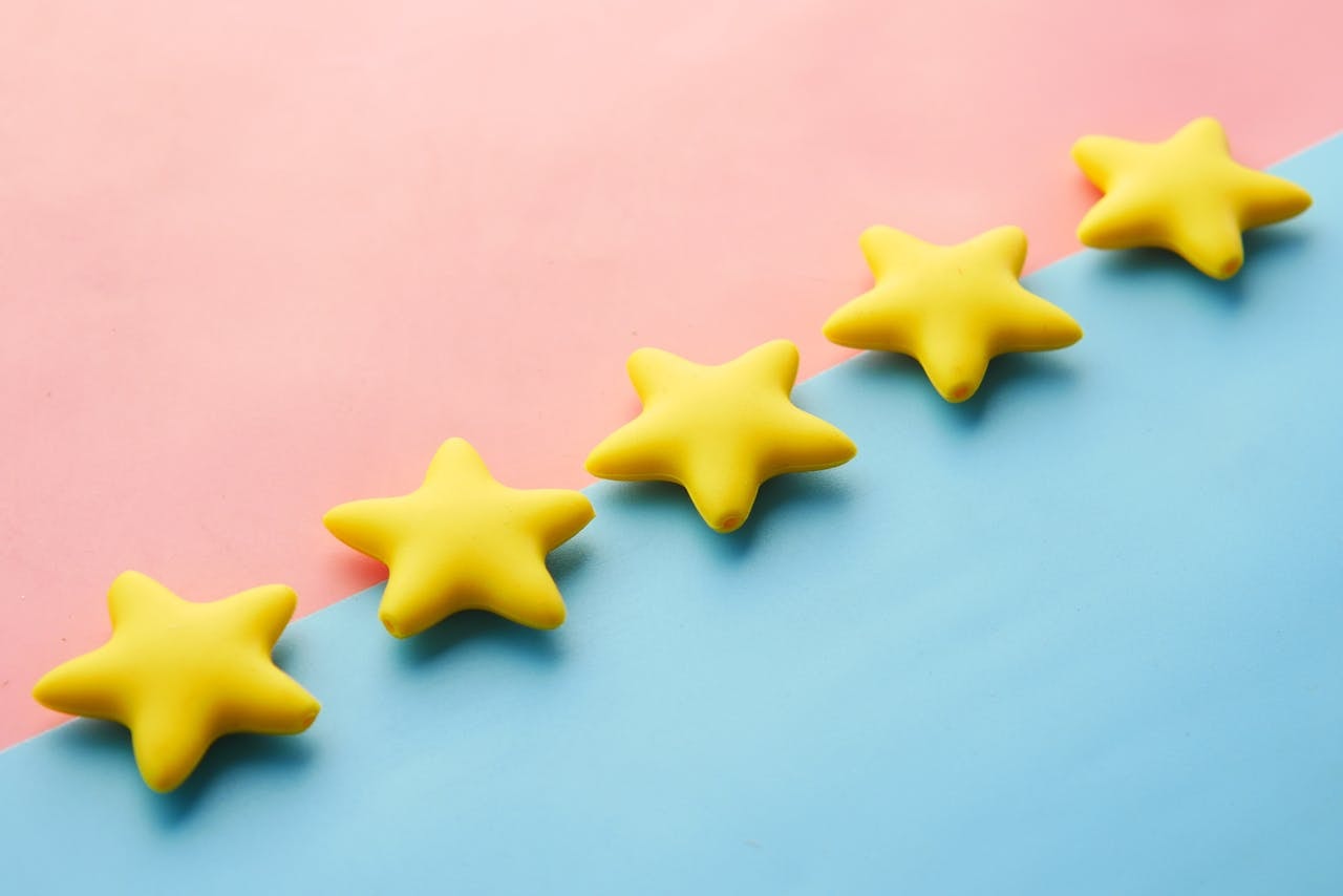 Five yellow stars on pink and blue background