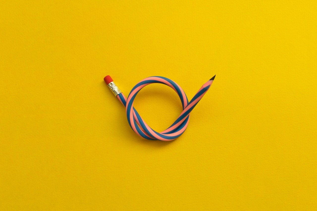 Flexible pencil isolated on yellow background.