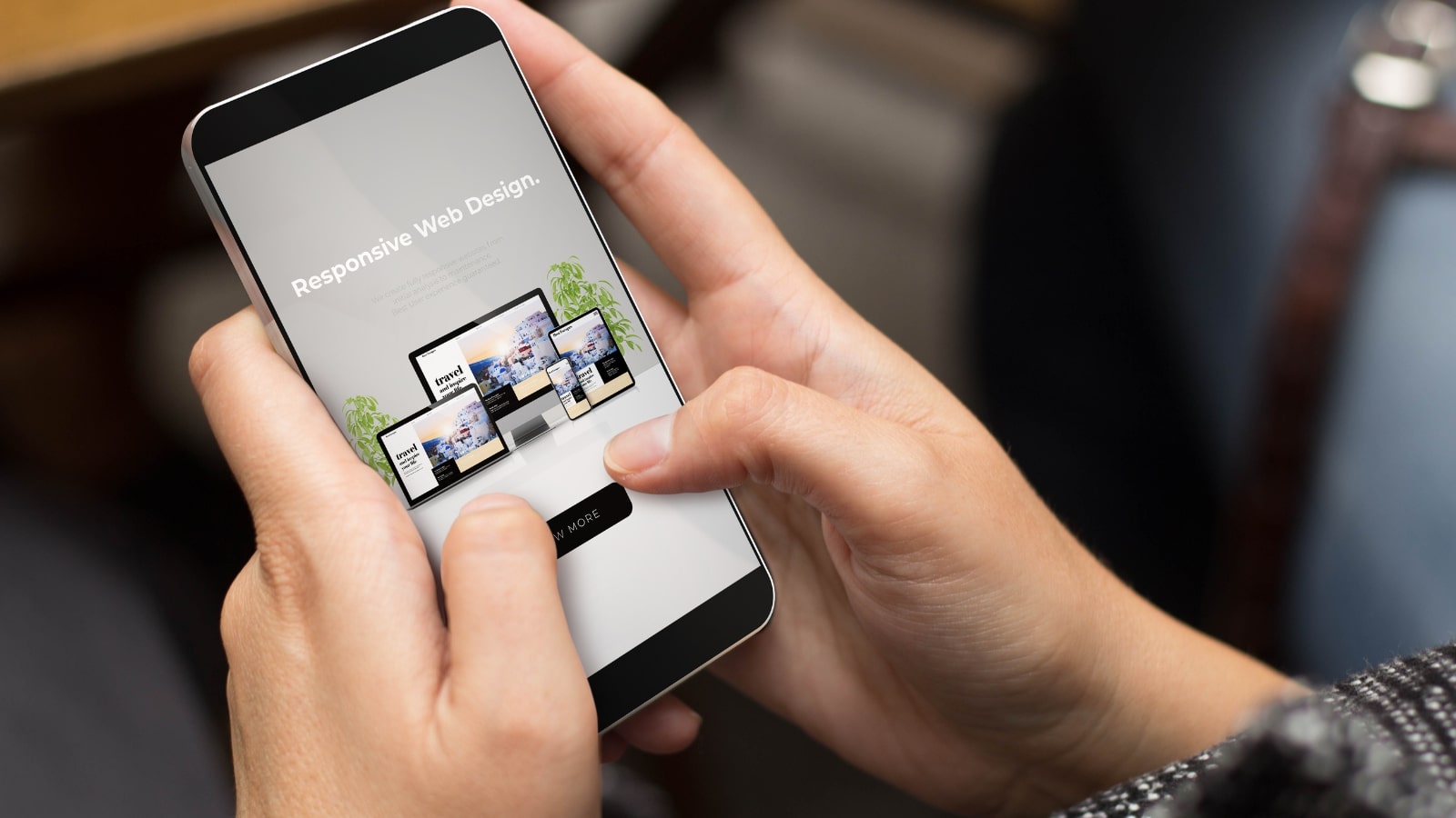 Girl using phone with screen showing responsive website design.