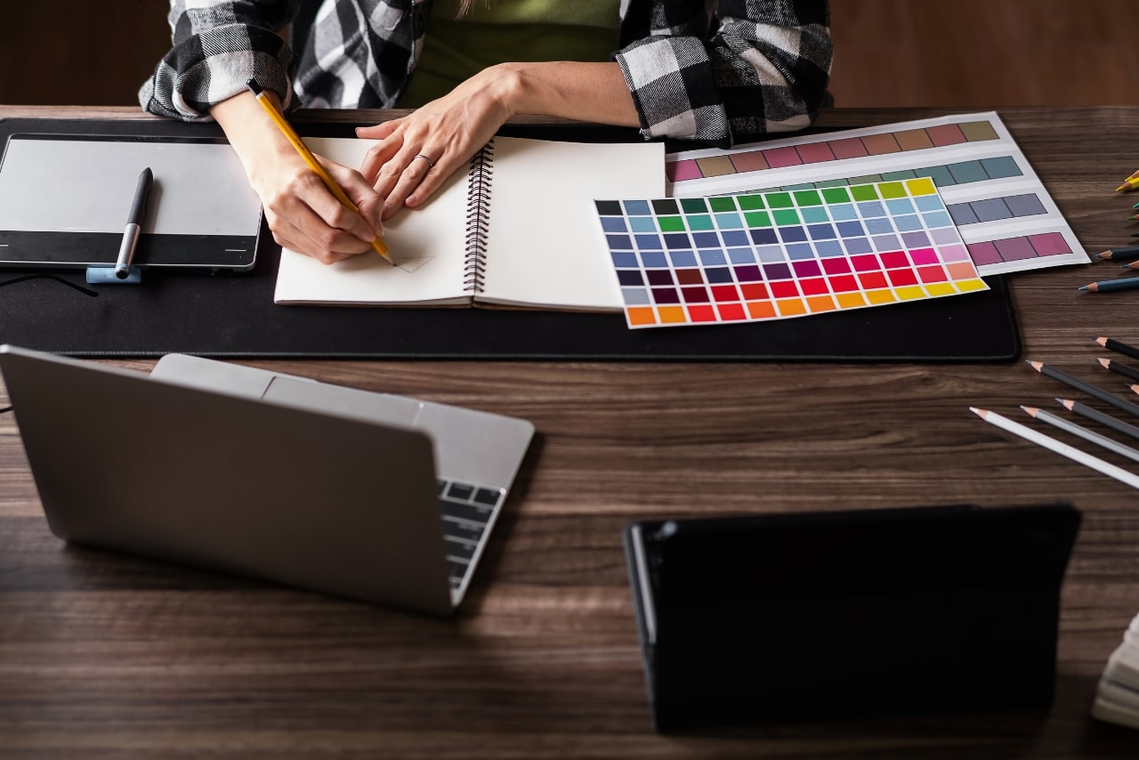 Graphic designer working with sketching logo design at office.