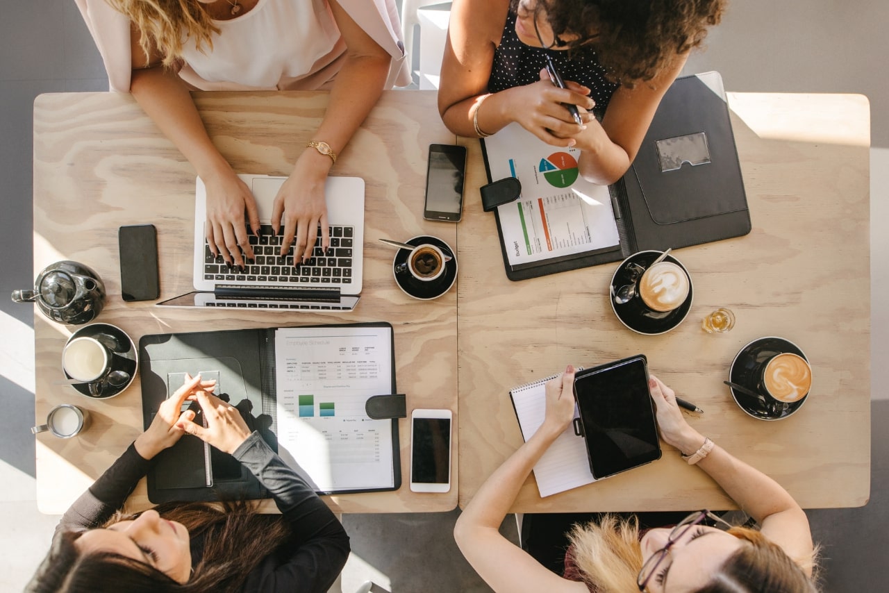 Group of Women Working Together in Coffee Shop.