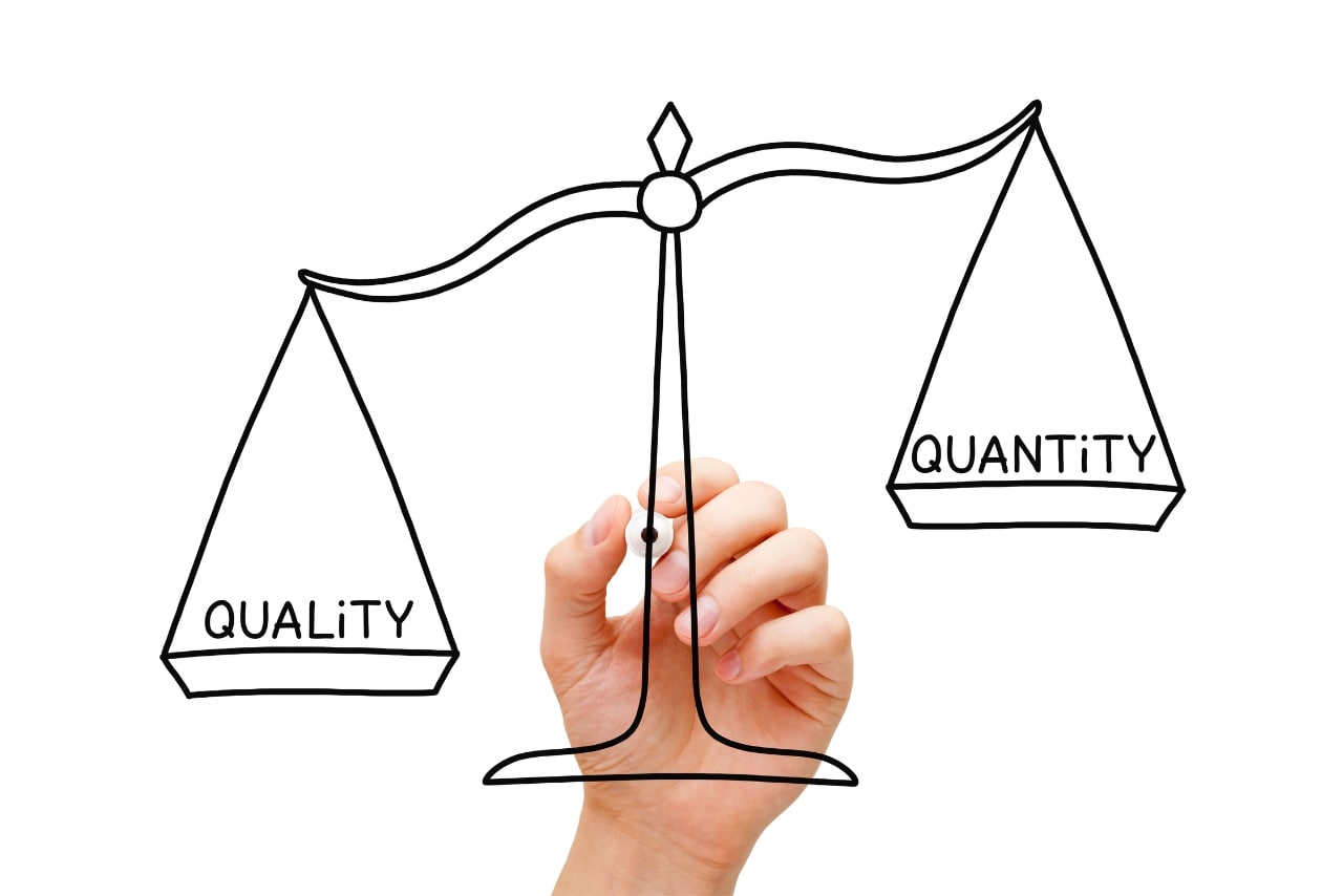 Hand drawing scale to illustrate quality over quantity.