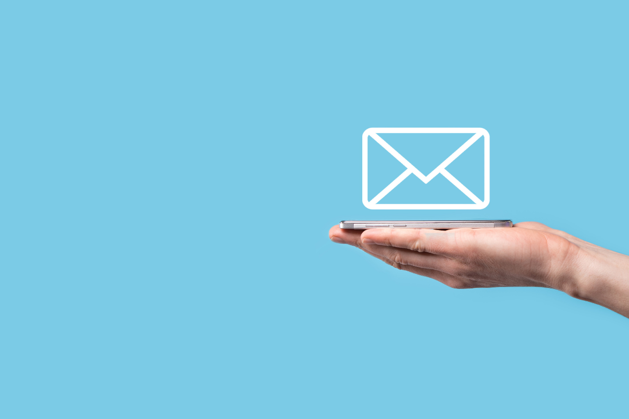 Male hand holding to letter icon and phone.