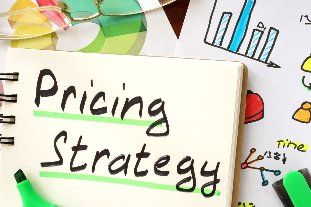 Notebook with Pricing Strategy written on it.