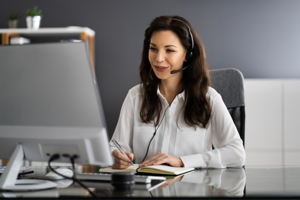 Nurse virtual assistant talking to someone online on her computer.