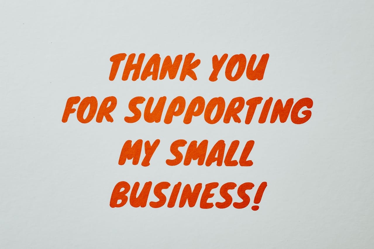 Orange text on white paper that says Thank you for supporting my small business!