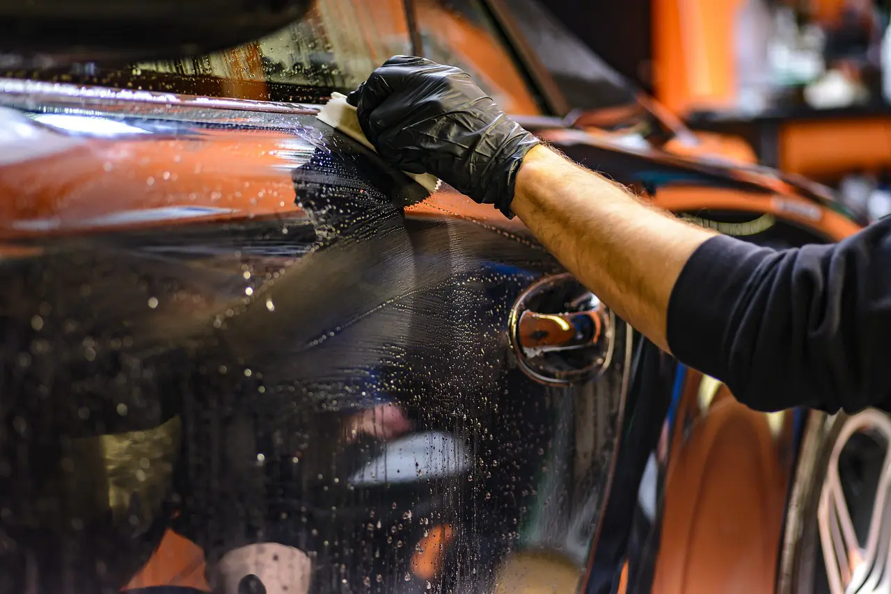 Person cleaning a car
