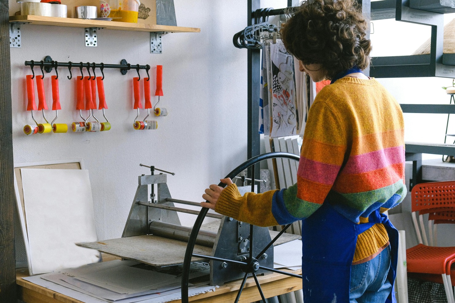 Person operating a retro printer.