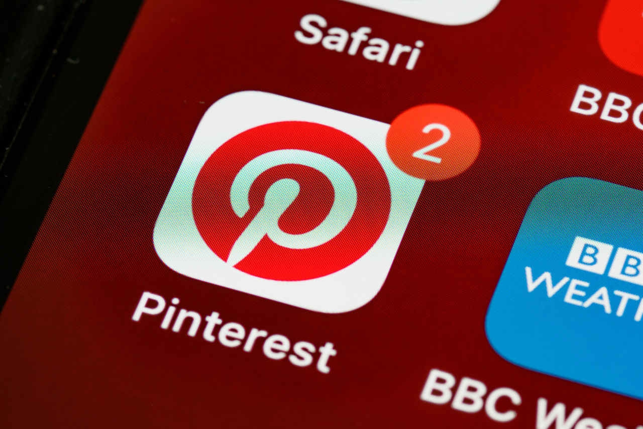 Pinterest's red logo on phone screen.