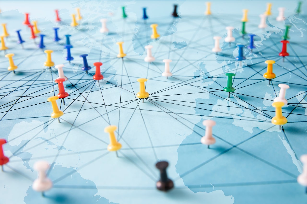 Push pins on a world map.