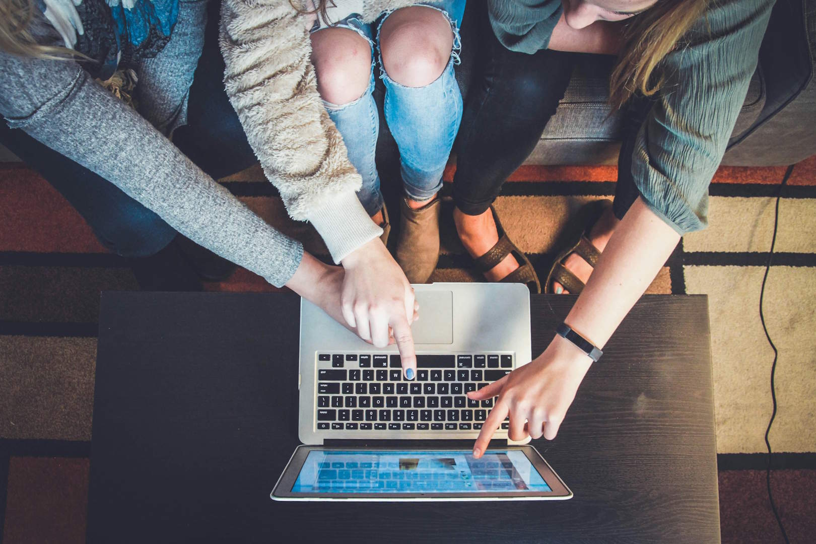 A group of people pointing out an advertisement online.