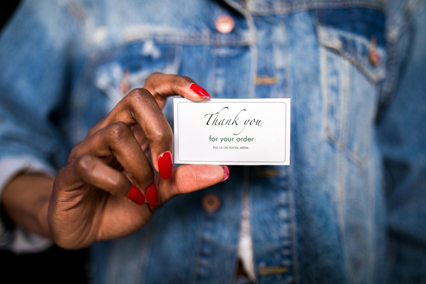 Woman holding a thank you note sent as a package insert