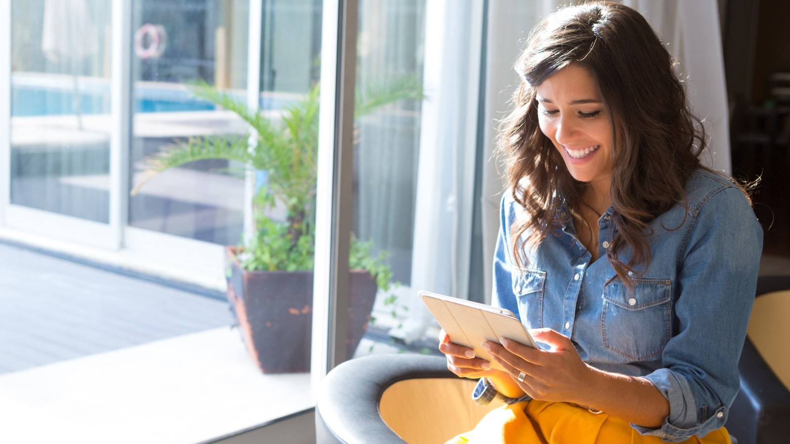Woman reading about her interested topic online using tablet.