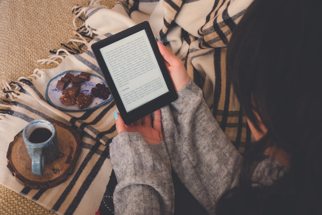 Woman reading an e-book in the e-book reader.