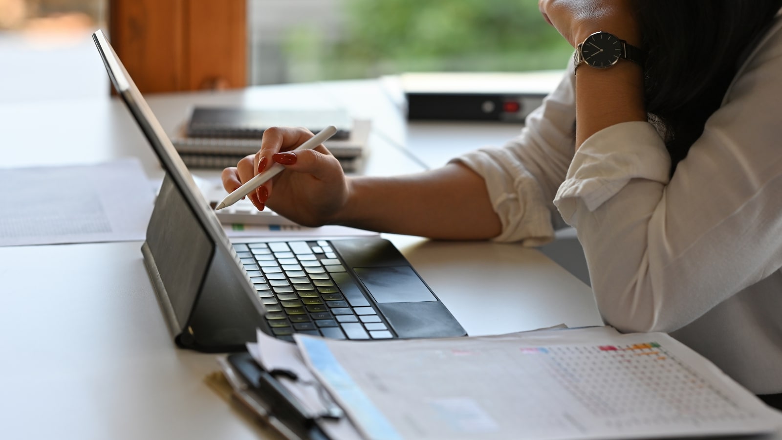 Woman uses tablet to do auditing and analyzing of content.