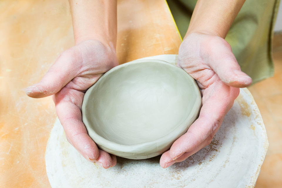Making of clay bowl by hand.