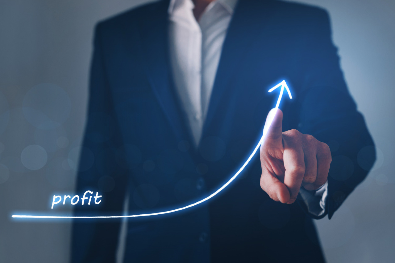 A businessman boosting a rising profit line.