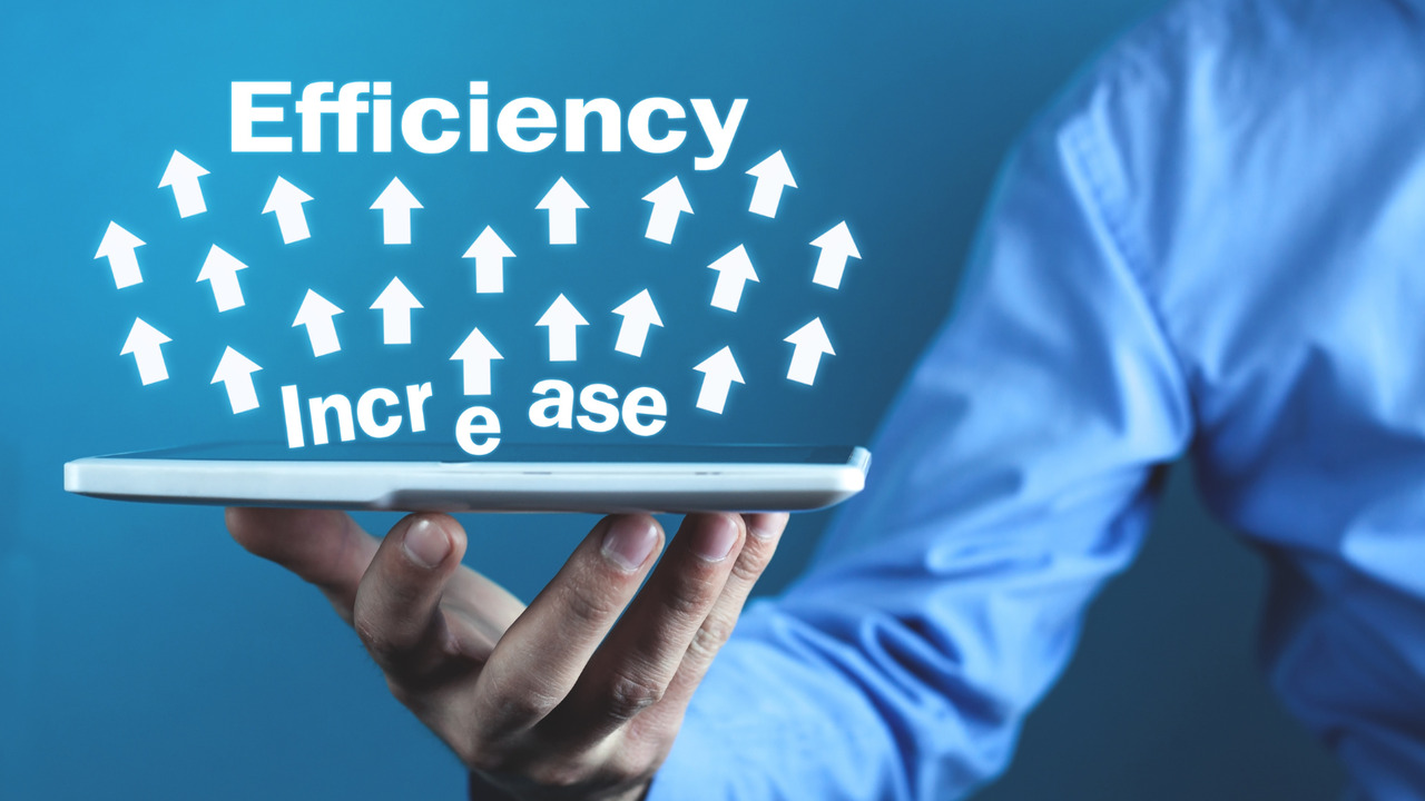 Businessman holding tablet illustrating efficiency increase concept.