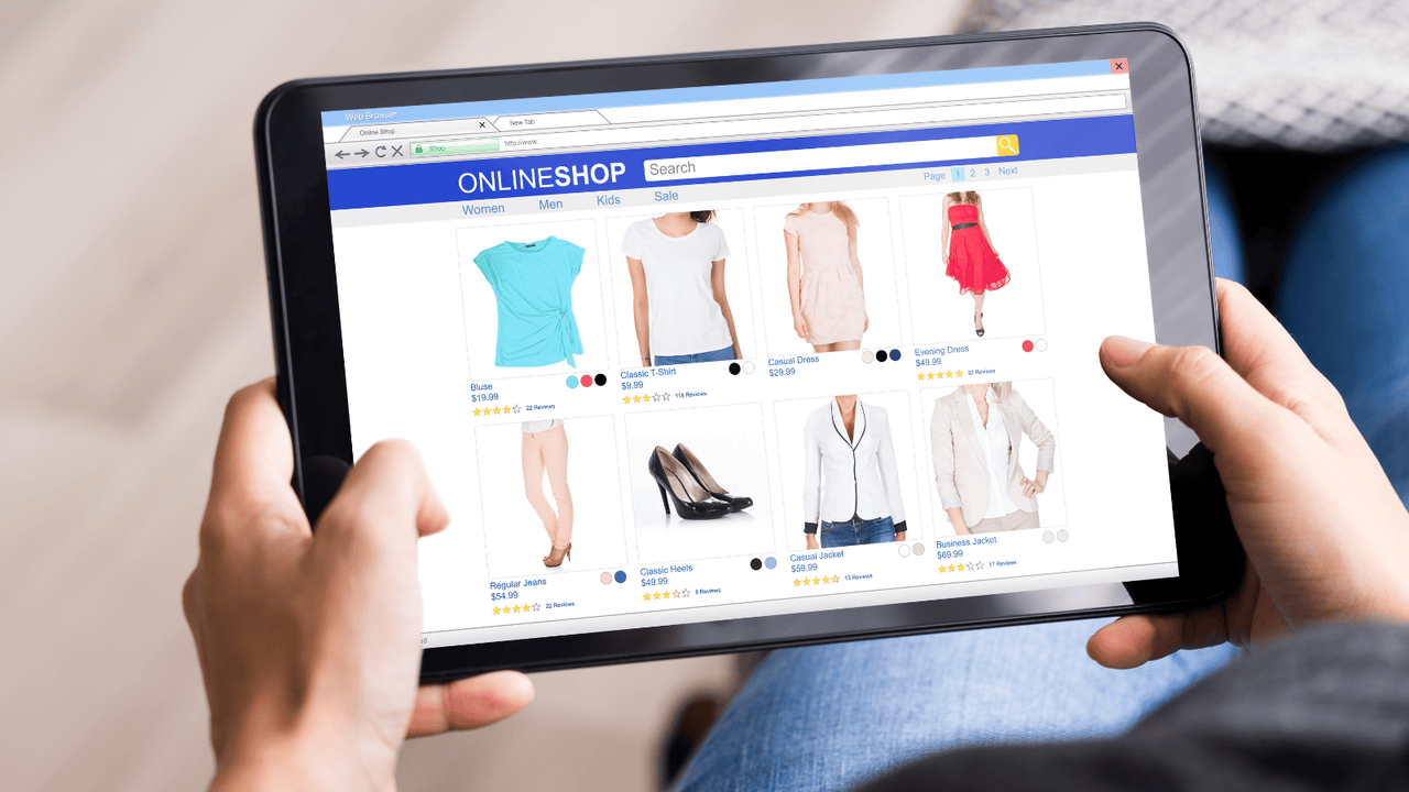Person doing online shopping for clothes on tablet.