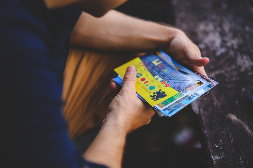 Man looking at postcards.