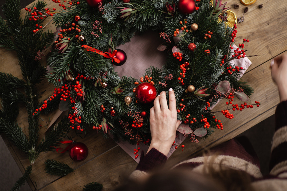 Woman making christmas wreath.