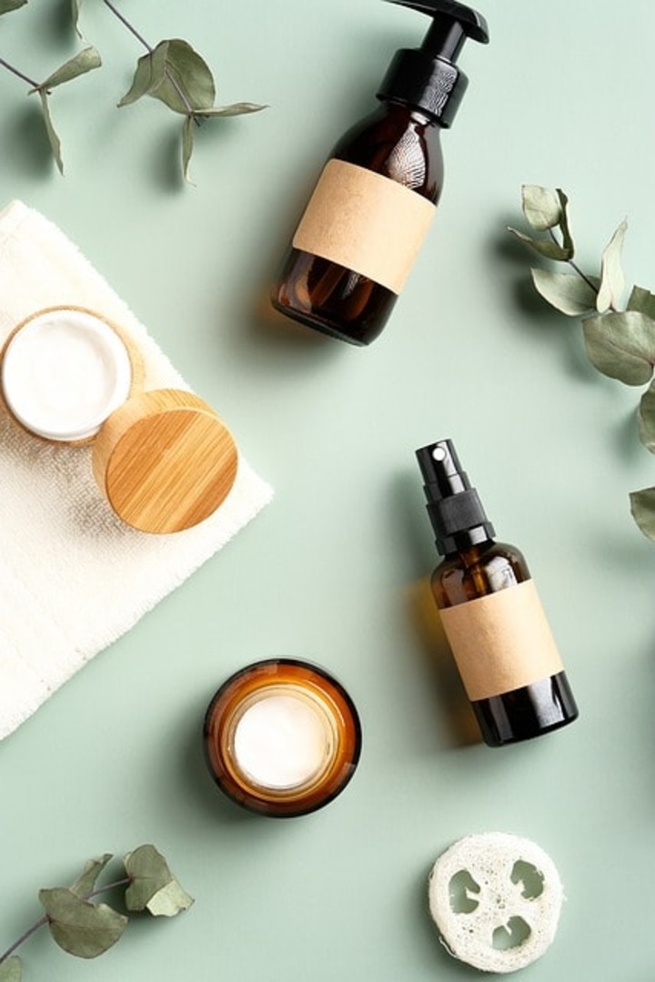 Bottles of beauty products horizontally placed on a surface.