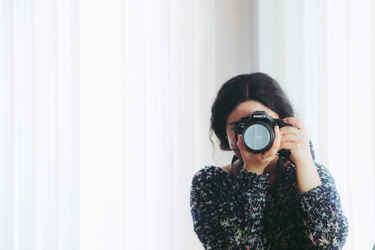 Woman in Black Long-sleeved Shirt Using Camera.