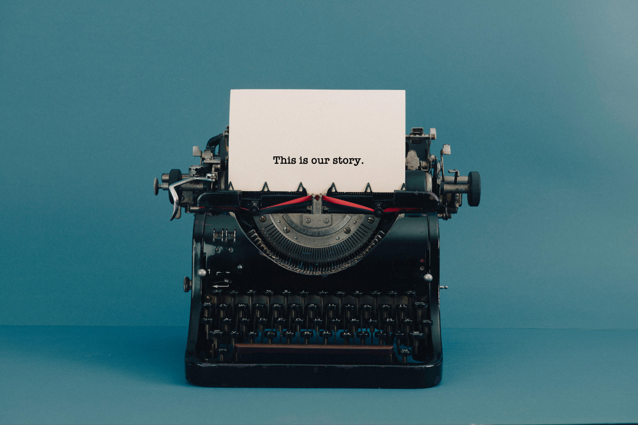 An old typewriter with a sheet of paper displaying the words, 