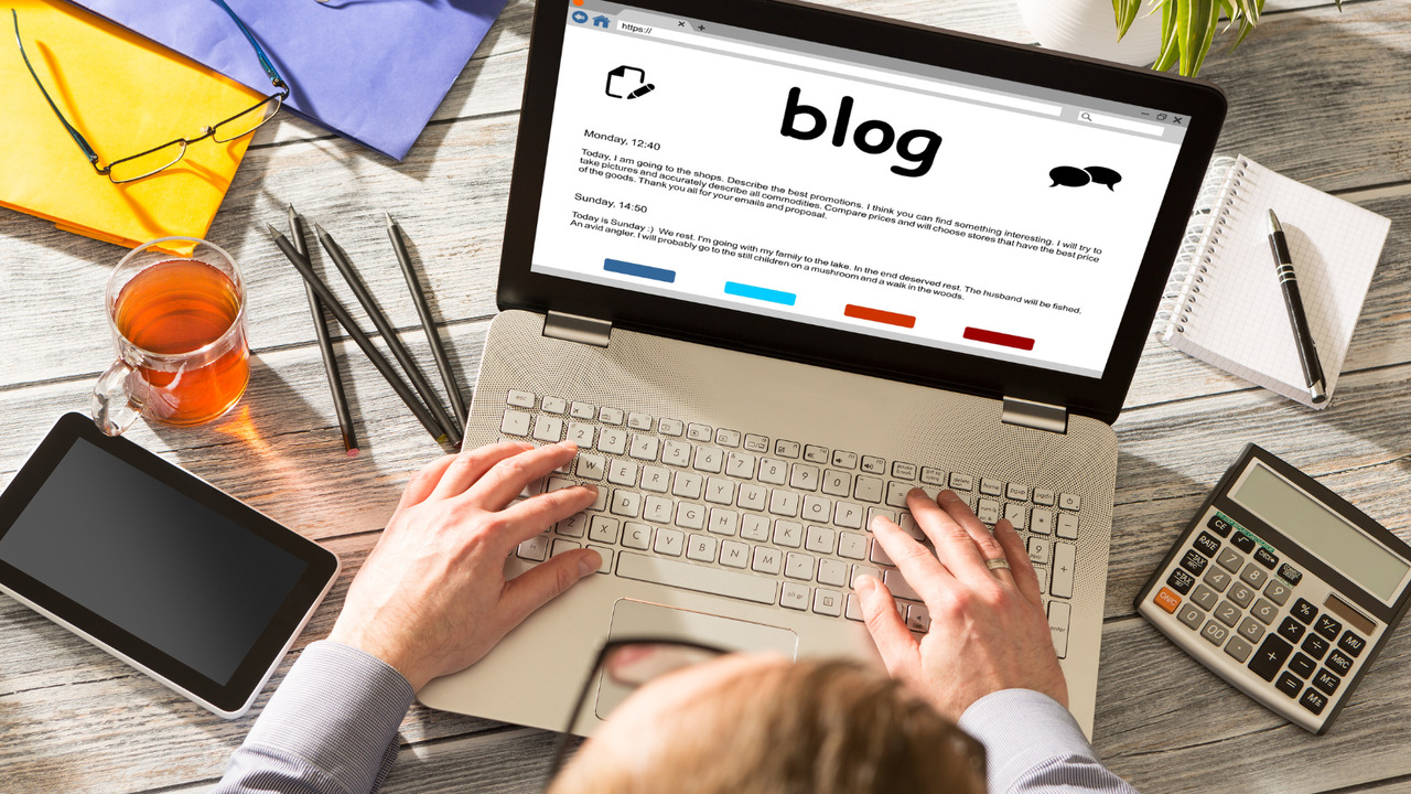 Person typing on laptop for a guest blog article.