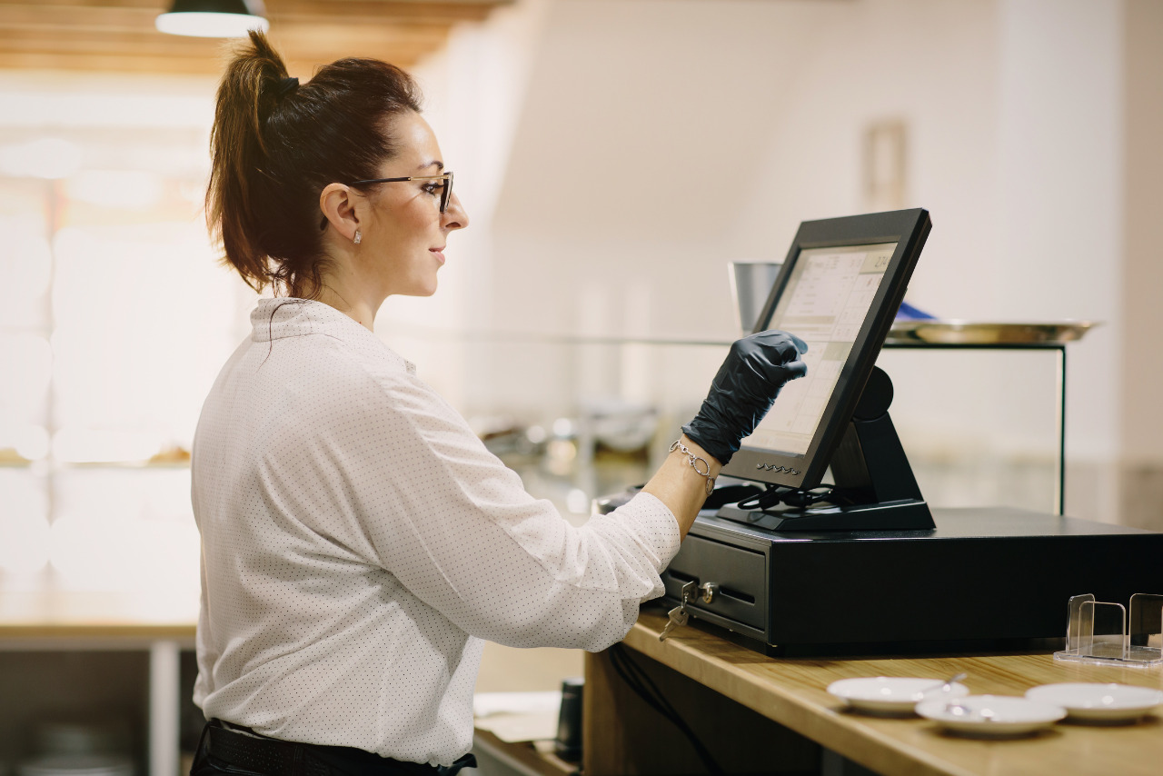 Salon staff working at a POS terminal.