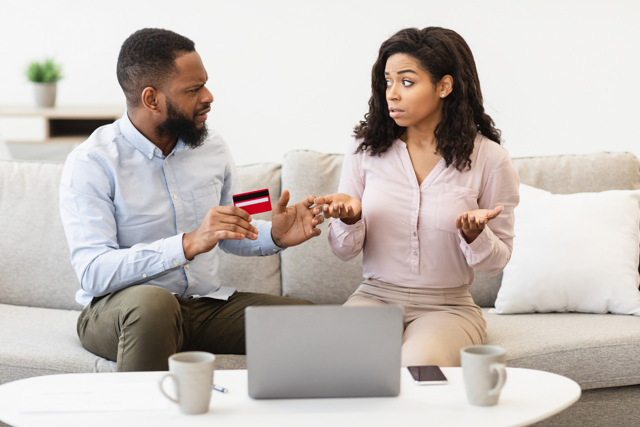 Couple small business owners arguing about credit card overspending.