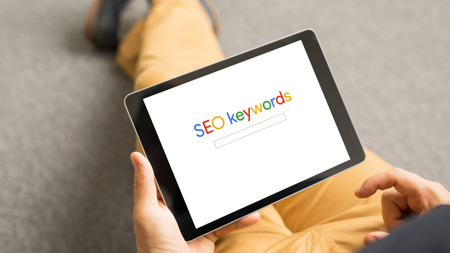 Person brainstorming with SEO keywords on ipad. 