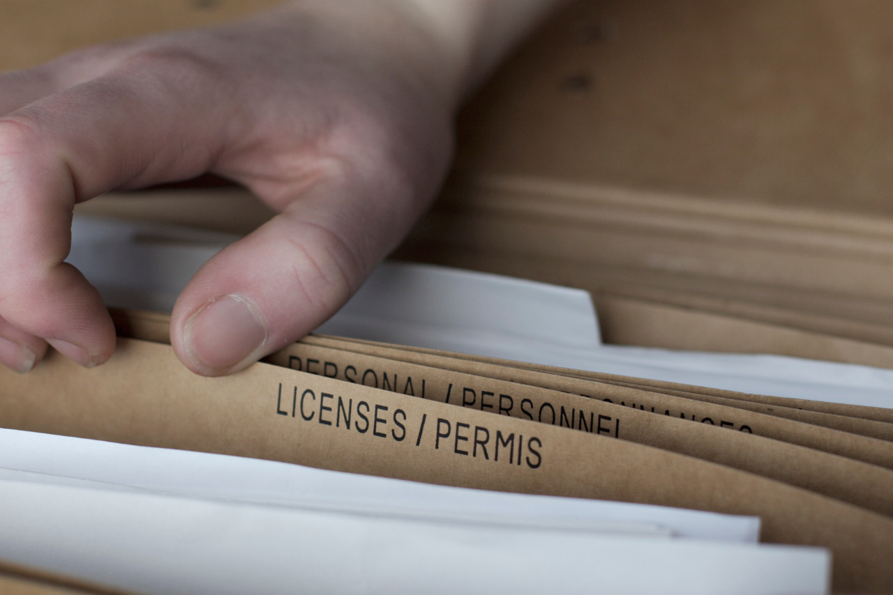 A hand scrolls through several folders before pausing on one labeled 