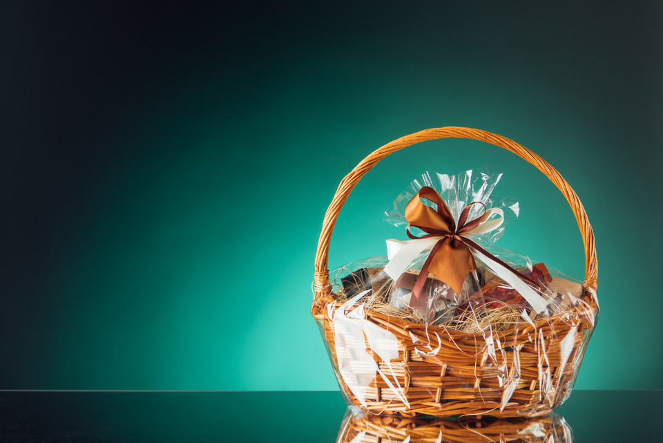 Gift basket on emerald background.