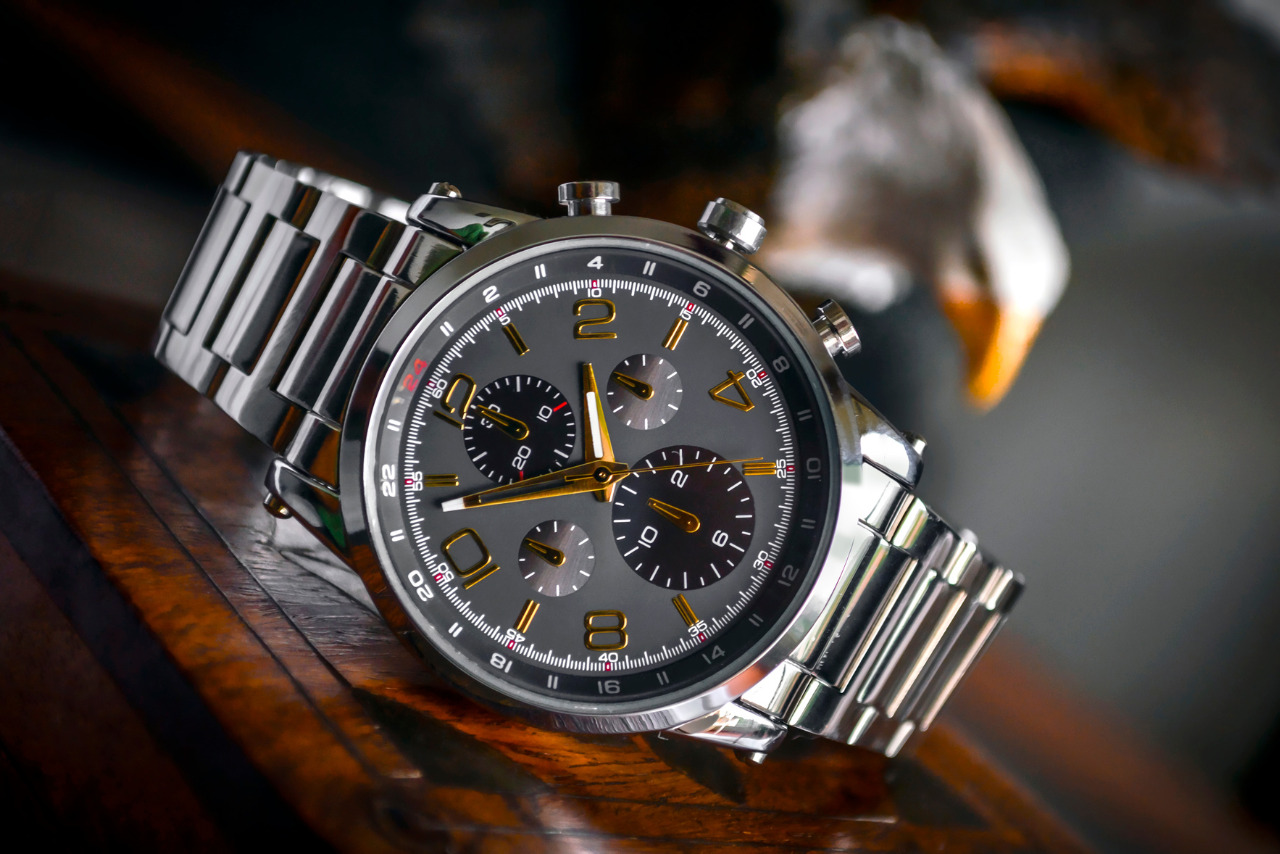 Silver linked bracelet silver and black round chronograph watch.