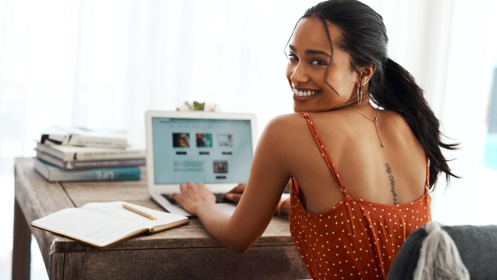 Smiling woman successfully posting a new blog.