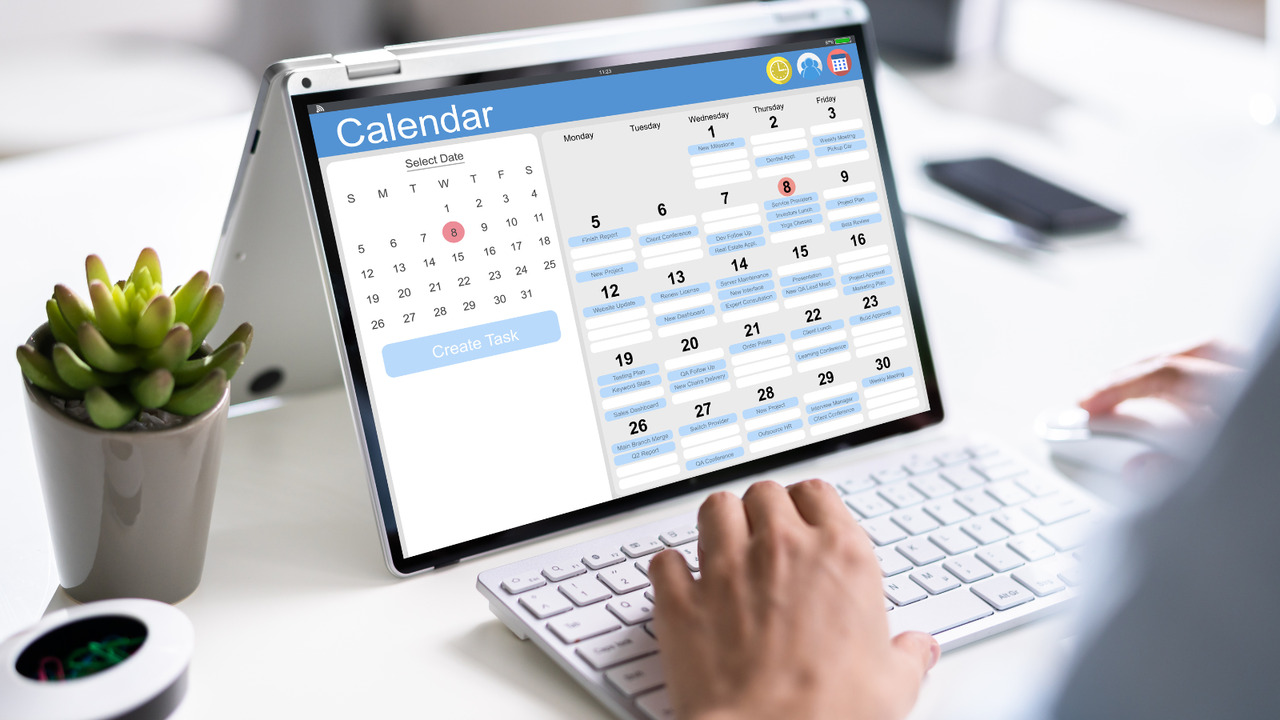 Person creating an email content calendar on tablet.
