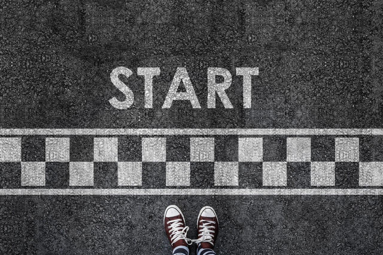 Man's sneakers at the starting line.