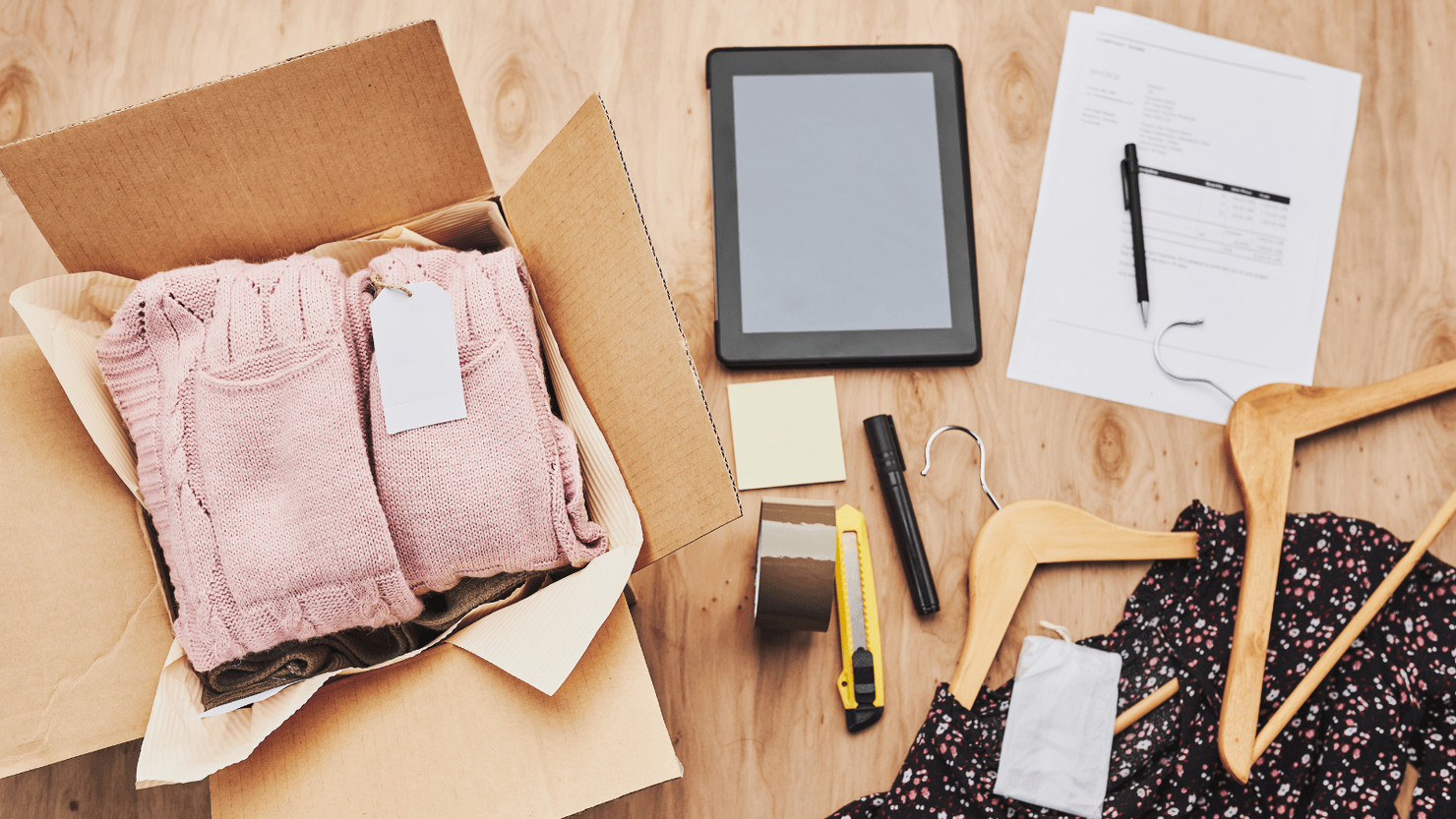 Preparing parcel box with clothes product from online shop.