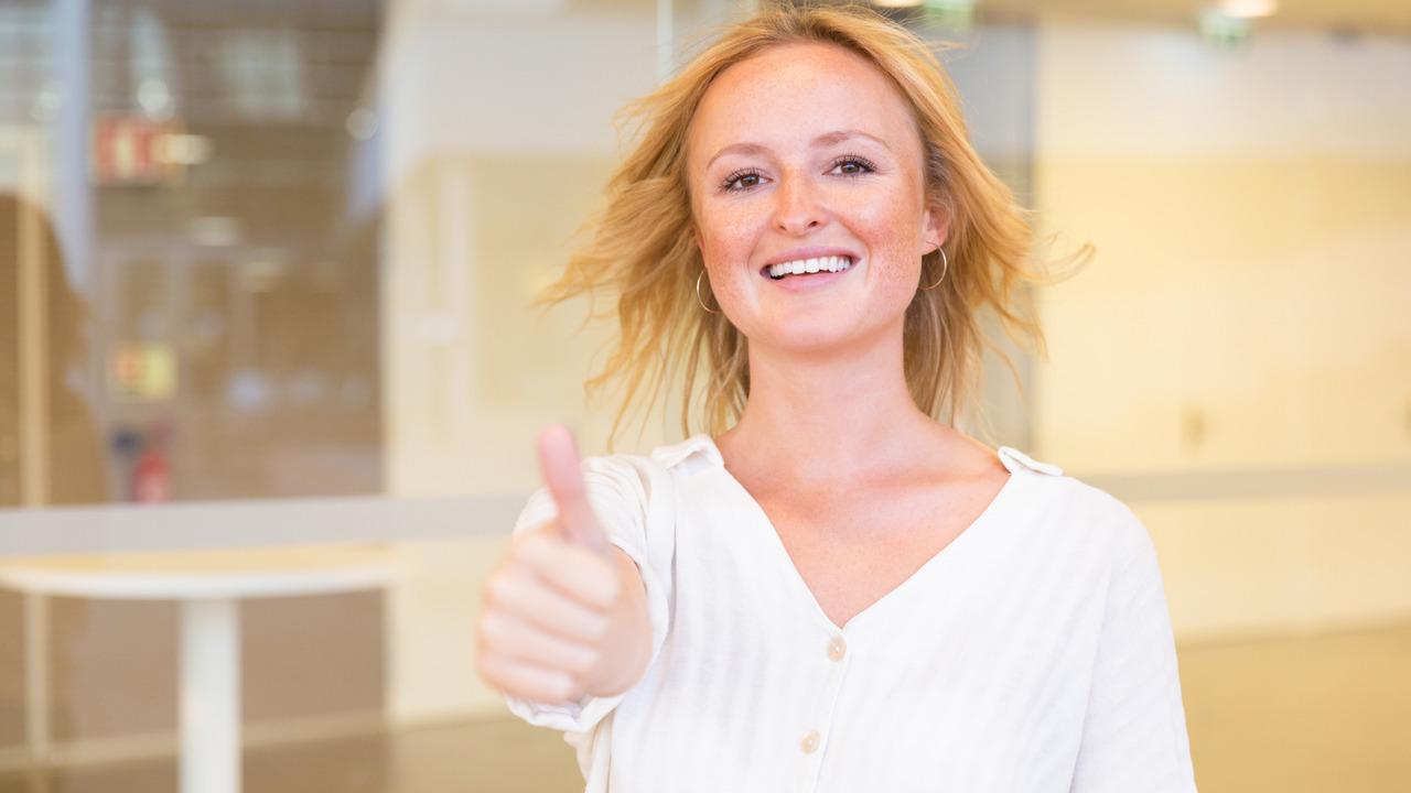 Happy satisfied coaching client making like gesture.